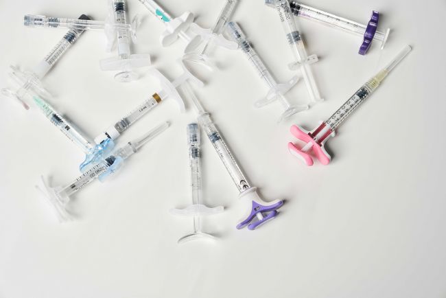 syringes-filled-with-liquid-inside-white-background-view-from-multiple-hypodermic.jpg